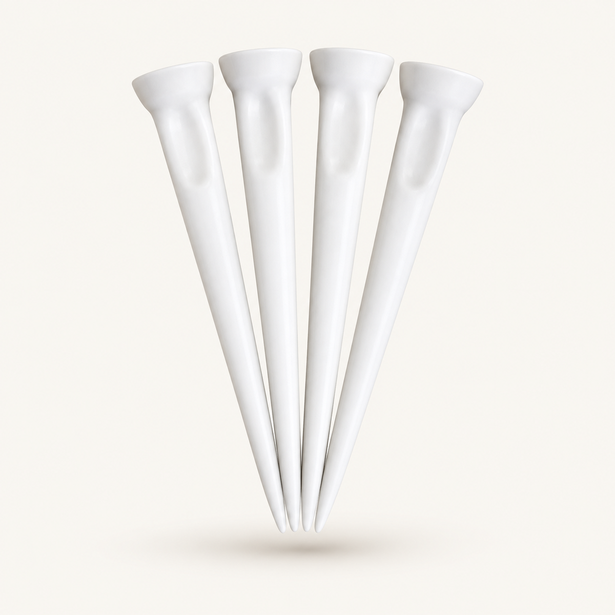 Four solid white HEP Tees Pro golf tees on a warm off-white background
